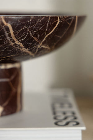 Korinza cherry red marble bowl displayed on a book