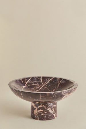 Korinza cherry red marble bowl styled on a coffee table