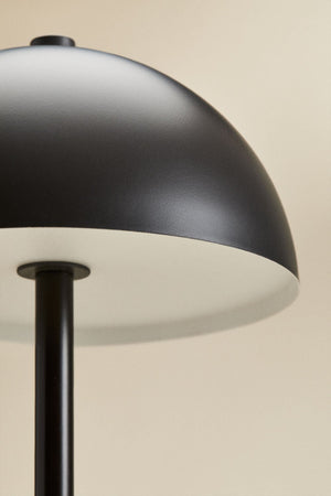 Nicolas wireless LED lamp – second lifestyle shot on book on white surface, lamp unlit, showing clean silhouette and proportions