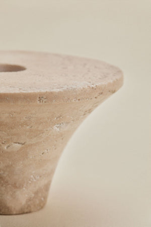 Bellvion travertine candle holder – top-down view showing the circular disc top, central Ø2 cm candle socket, and raw chalky travertine surface texture