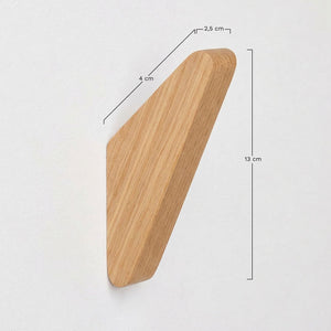 Brana wooden wall hooks – lifestyle close-up of dark walnut hook on textured wall, natural linen tote bag hanging by its strap, warm afternoon light casting shadow