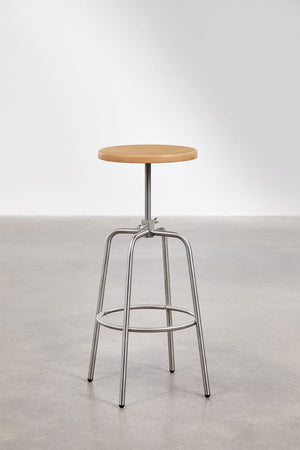 Bangalore high stool – lifestyle shot in kitchen setting, natural beechwood seat, stainless steel frame against grey panelled wall