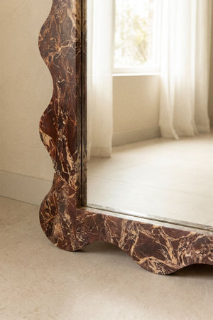 Bayaibe mirror – three-quarter view leaning against white wall, full height